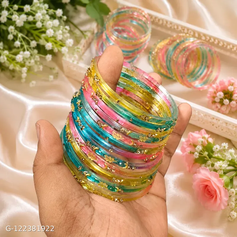 These Shevibe transparent multicolor glass bangles feature gold dotted details.