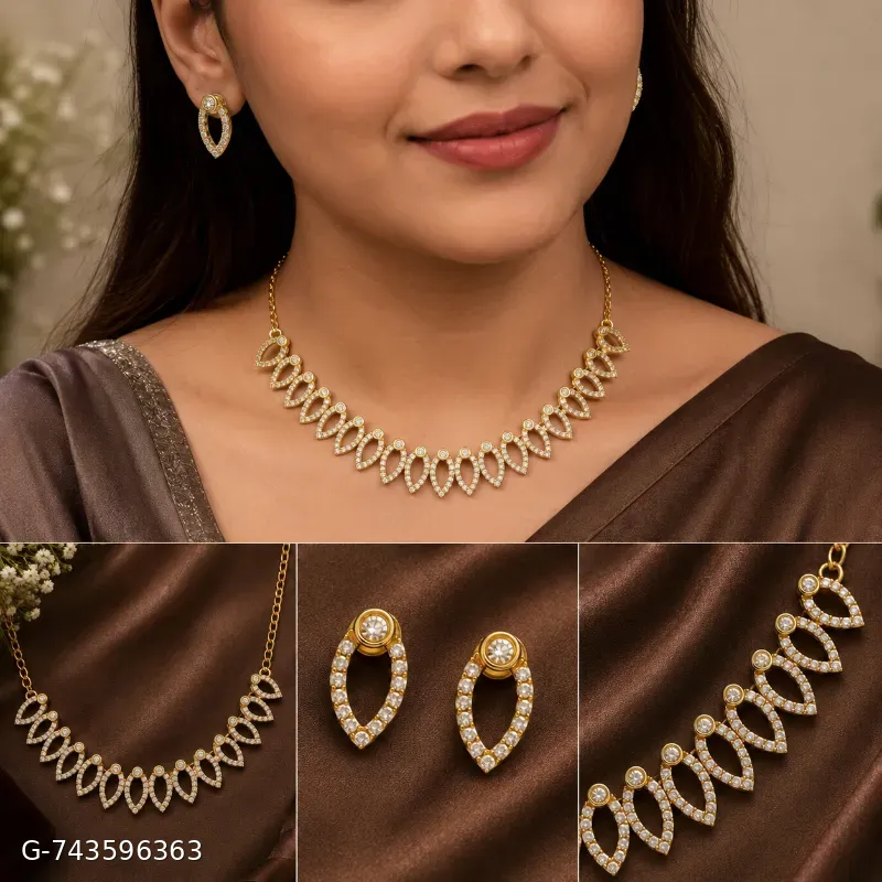 This is an elegant gold-plated necklace and matching earring set featuring delicate leaf-shaped motifs studded with sparkling cubic zirconia stones