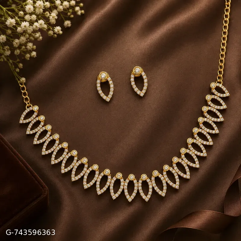 This is an elegant gold-plated necklace and matching earring set featuring delicate leaf-shaped motifs studded with sparkling cubic zirconia stones