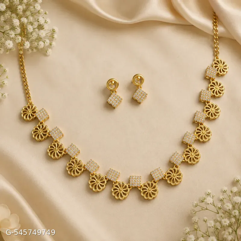 The image shows a gold-plated floral and crystal square-link necklace set with matching geometric stud earrings