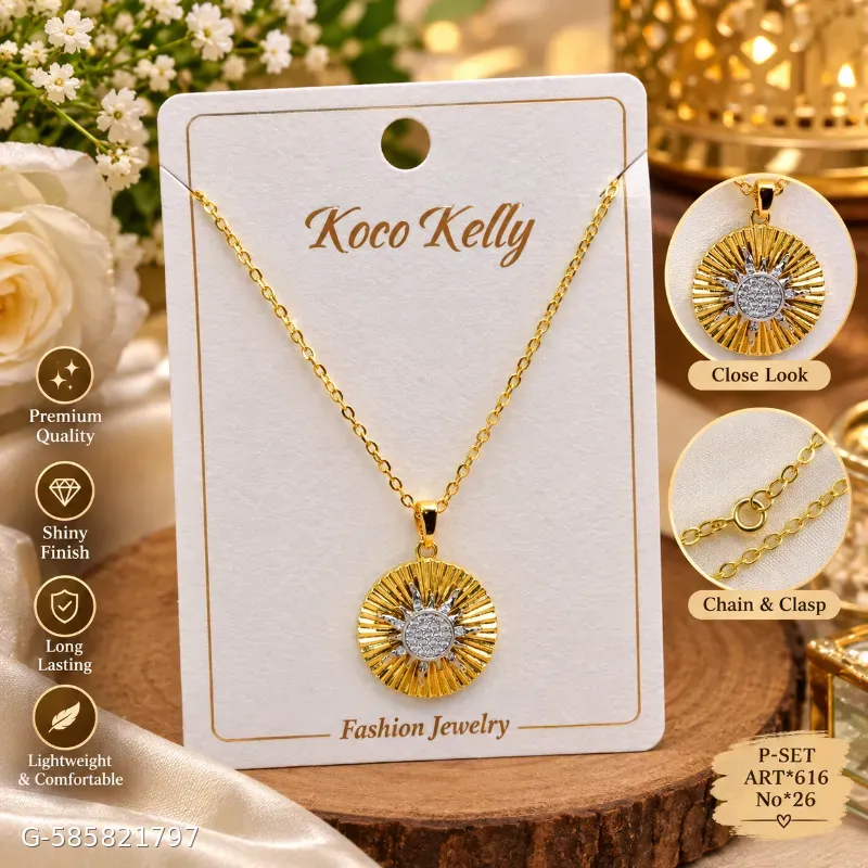 This is a gold-toned sun pendant necklace by Koco Kelly featuring a textured sunburst design with a sparkling center and a matching link chain.