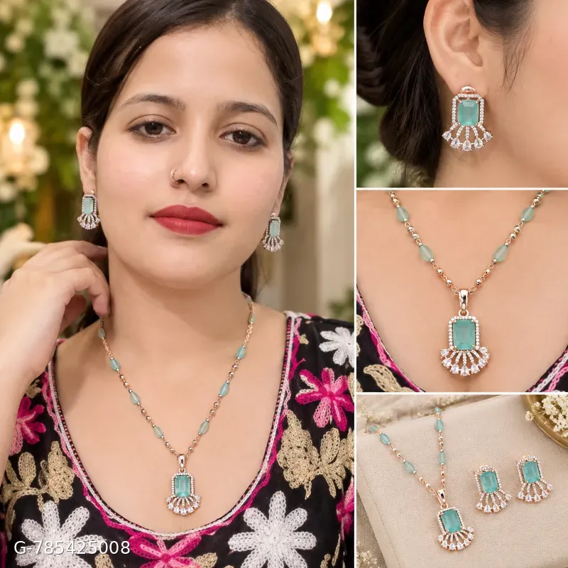 This is a silver-toned necklace and earring set featuring striking sea-green emerald-cut stones accented with sparkling cubic zirconia