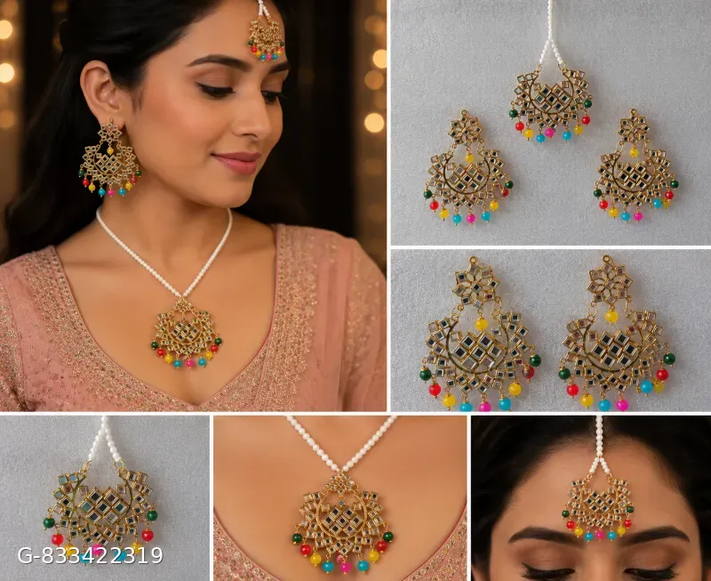 This classic multi-color Jhumka set with maang tika features gold-plated alloy construction adorned with mirror work and vibrant beaded drop